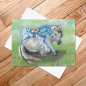 Greeting card of a gray Norwegian Fjord Horse with a blue Dala horse foal nuzzling her