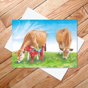 Greeting card of two jersey cows with a dala horse-inspired calf