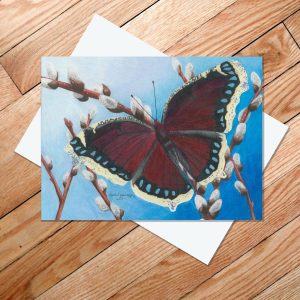 Greeting card of a mourning cloak butterfly resting on pussy willows