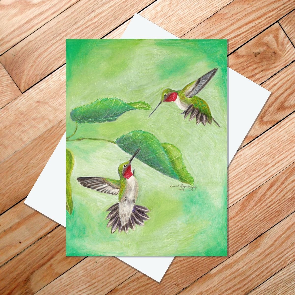 Greeting card of two male ruby-throated hummingbirds squaring off to fight