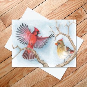 Greeting card of a mated pair of Northern Cardinals on a wintery branch