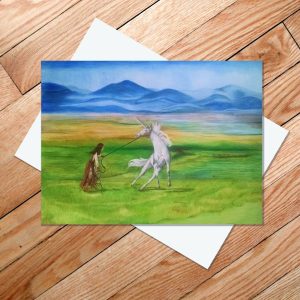 Greeting card of a girl taming a unicorn in the grasslands of the steppe