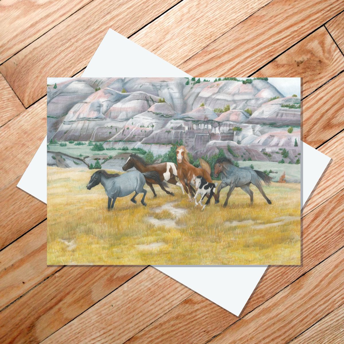 Greeting card of wild Nokota horses running through North Dakota badlands